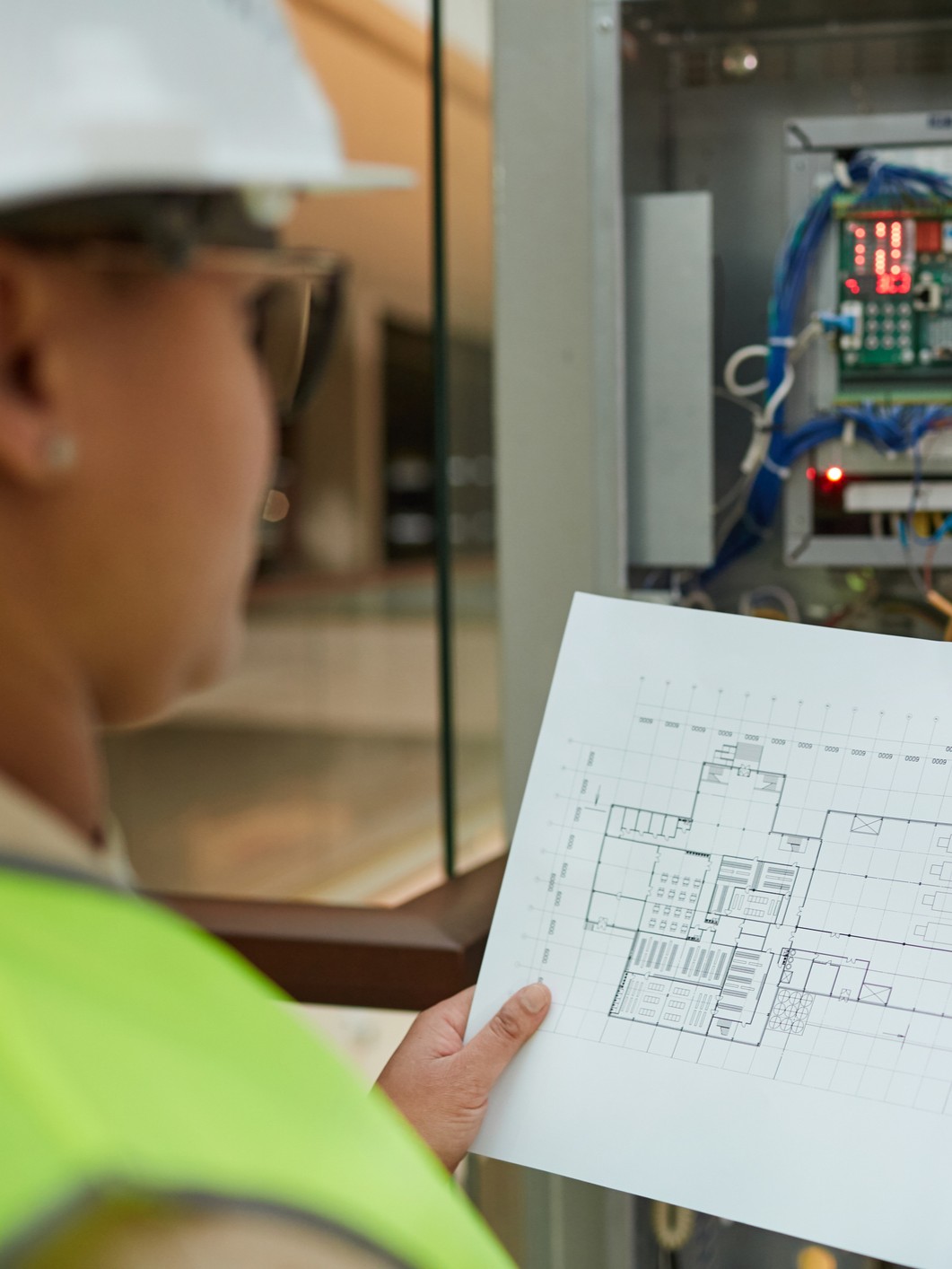 workers looking at field plan schematics