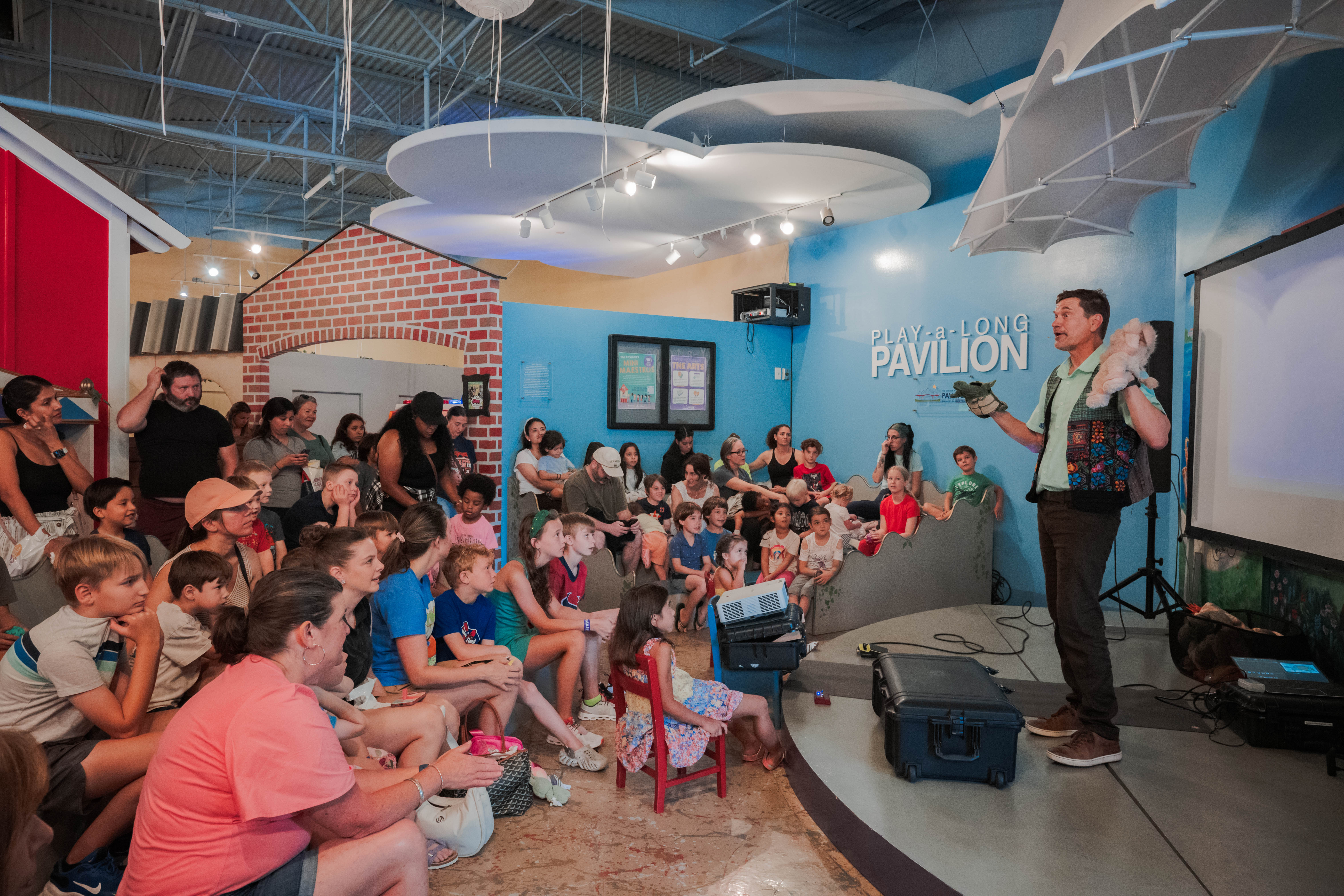 Engaging arts outreach performance with full crowd of kids
