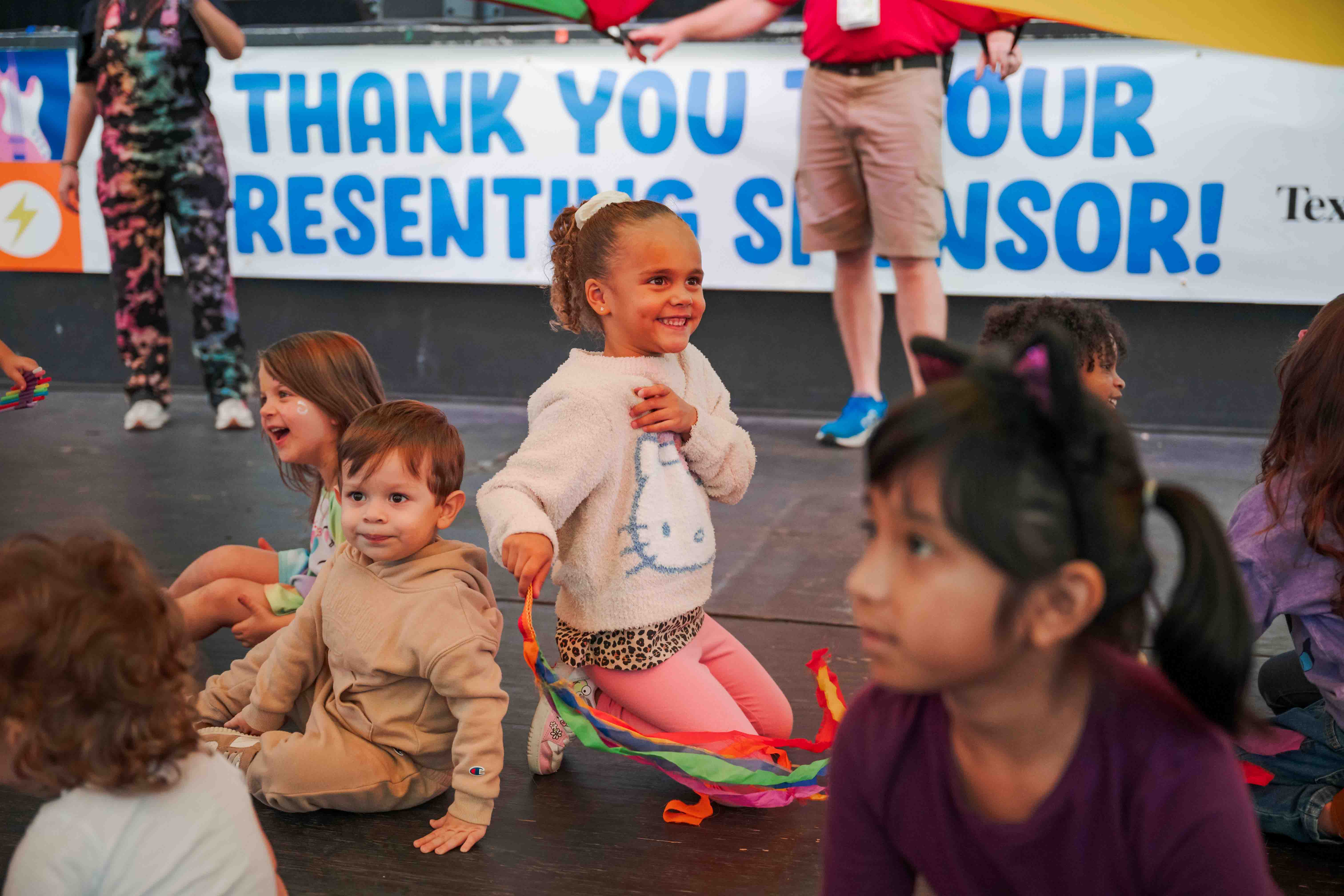Festival volunteers and community partners smile together.