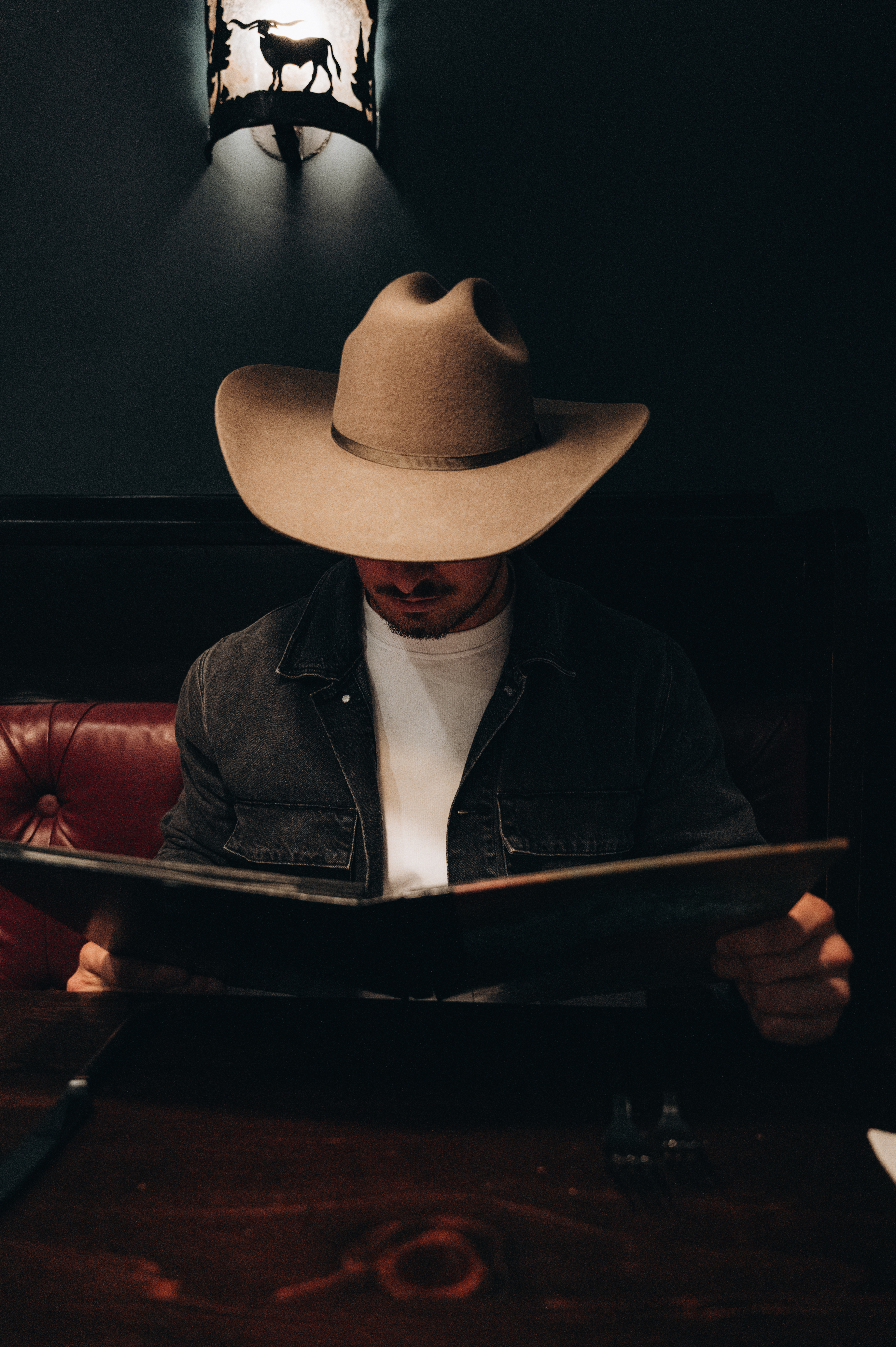 image someone reading a menu at the Million Dollar Cowboy Steakhouse 