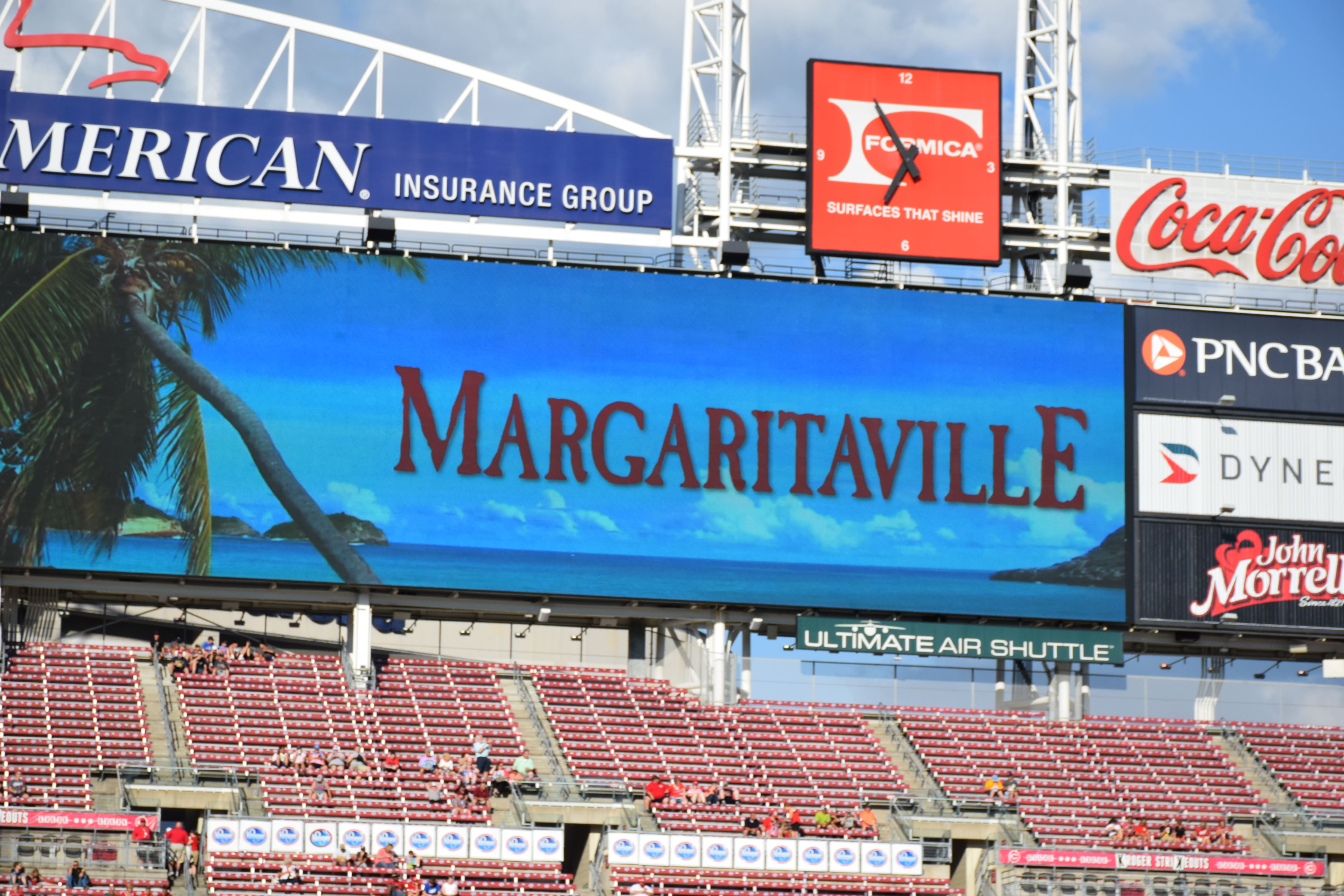 The outfield scoreboard at a baseball stadium displaying a tropical Margaritaville graphic