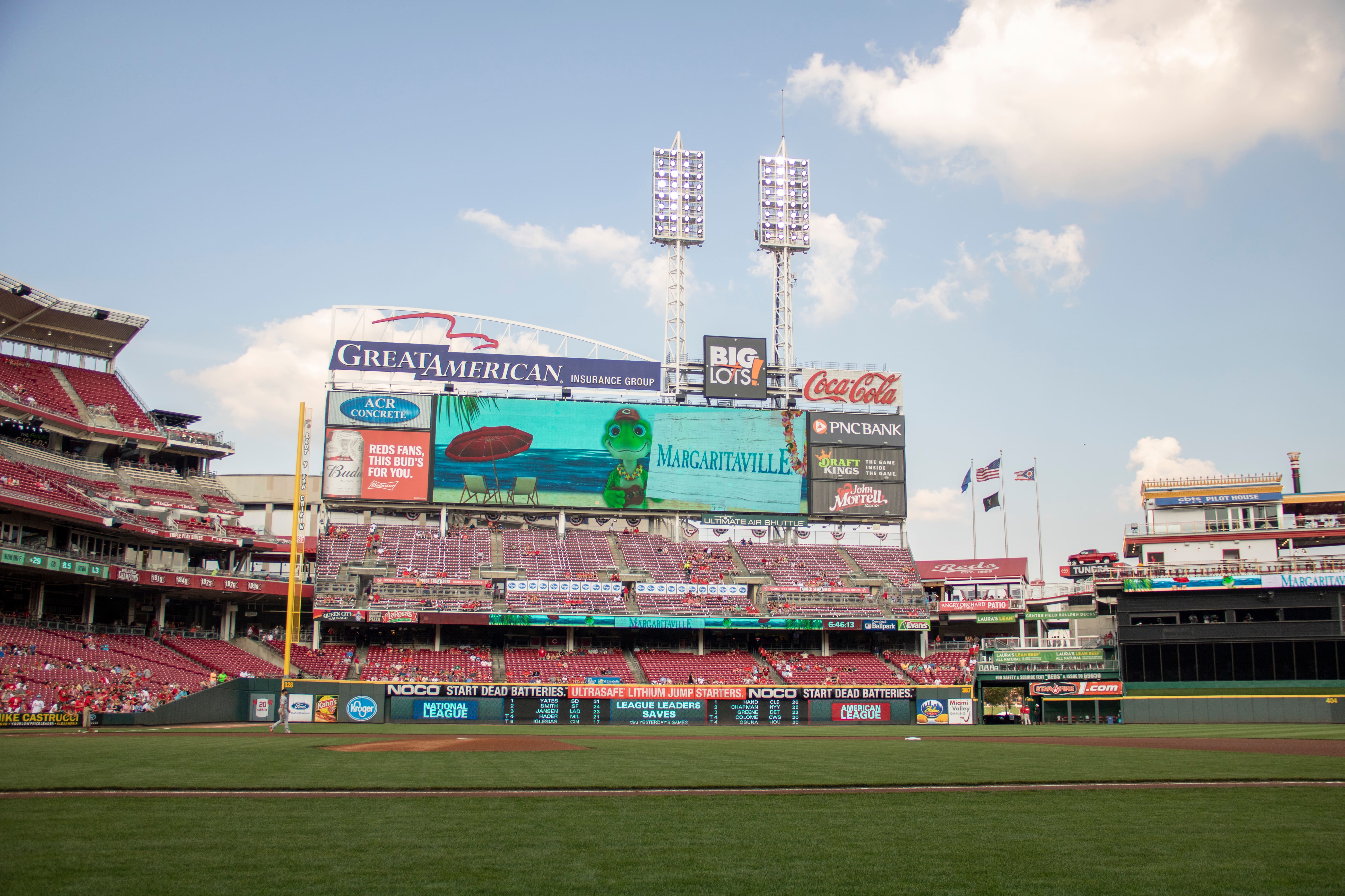 A stadium view of a Cincinnati Reds baseball game featuring a large Margaritaville themed display