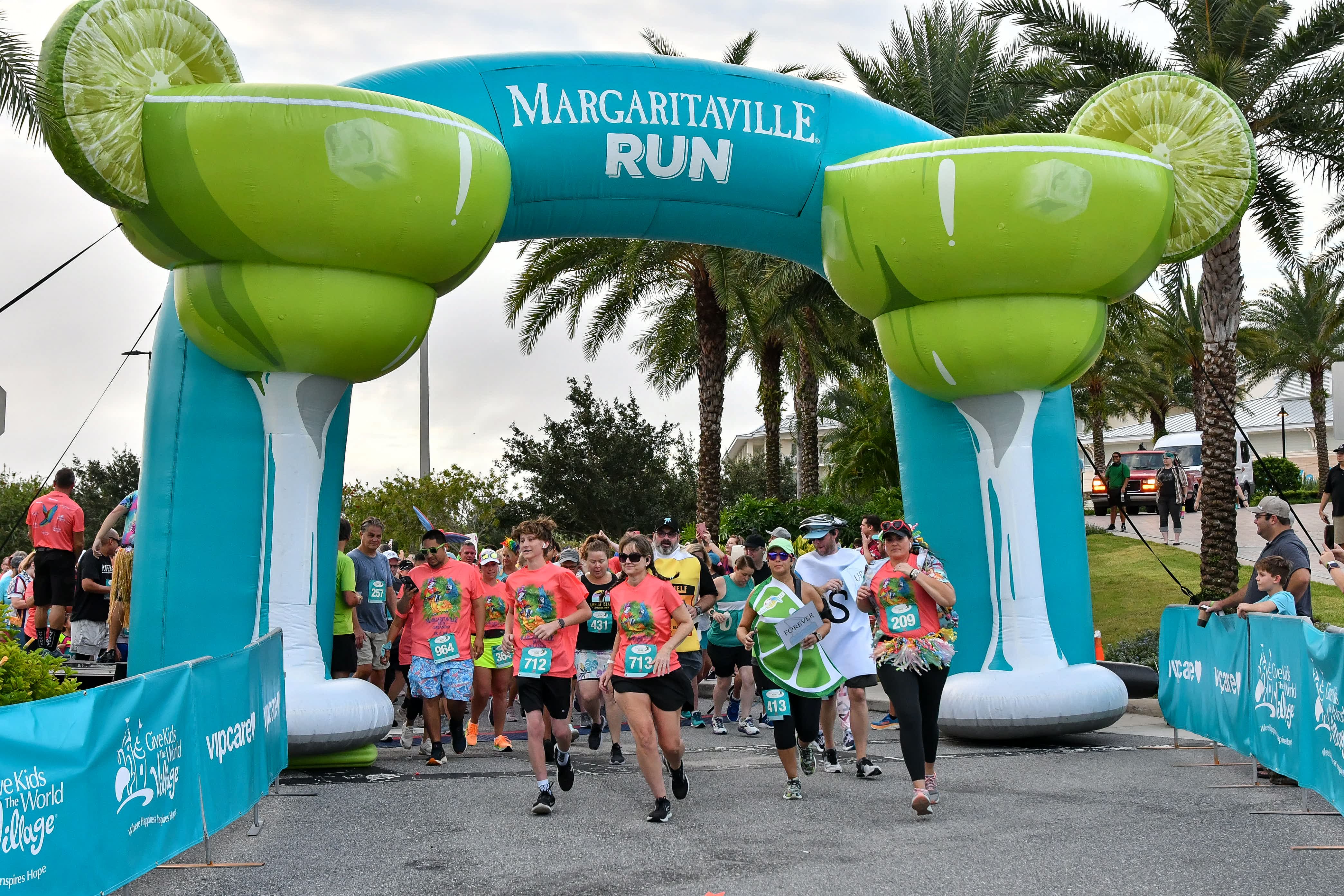 Runners begin a MARGARITAVILLE RUN by passing under a large inflatable archway