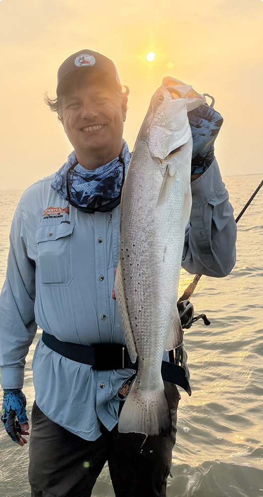 Michael Curran with a beautiful 7-pound summertime trout, first wade right out of the boat. MirrOlure Lil John did the trick. Hooked Up: August 2025